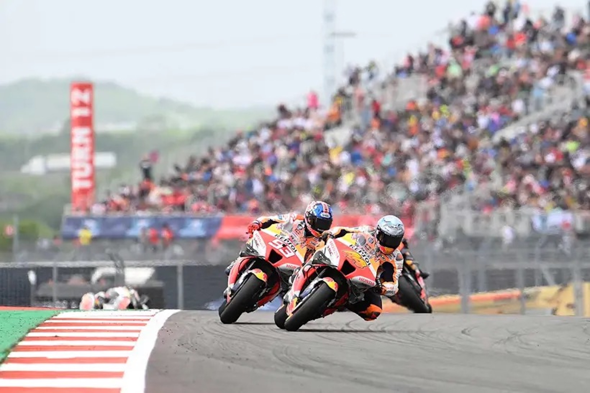 Honda's REPSOL team rounds the bend at a MotoGP circuit. Media sourced from MCN.