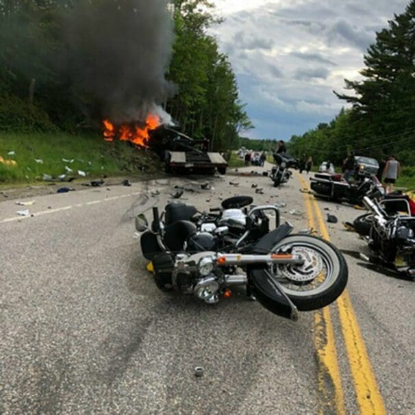 A view of a crashed motorcycle and truck accident.