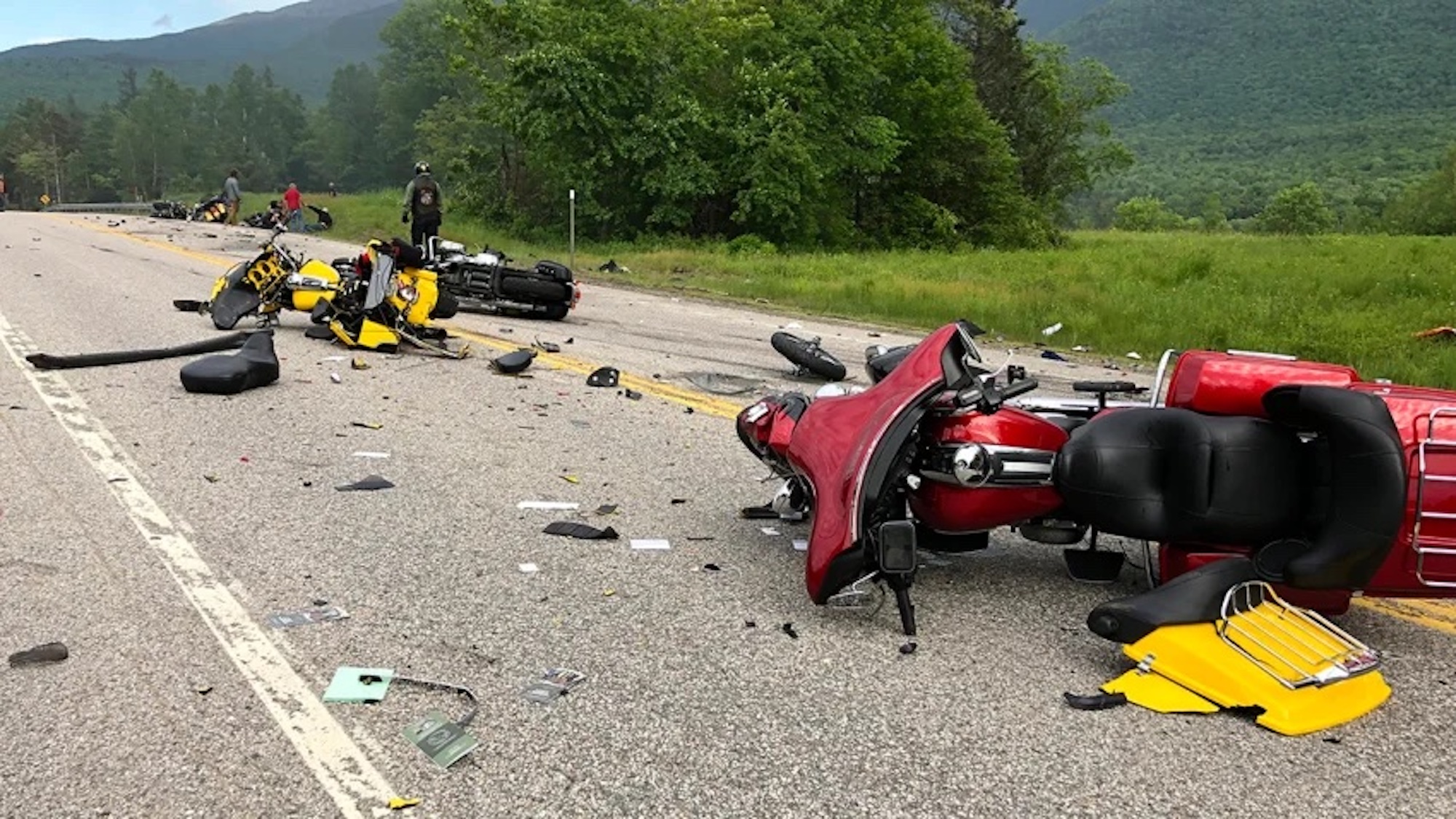 A view of a crashed motorcycle and truck accident.