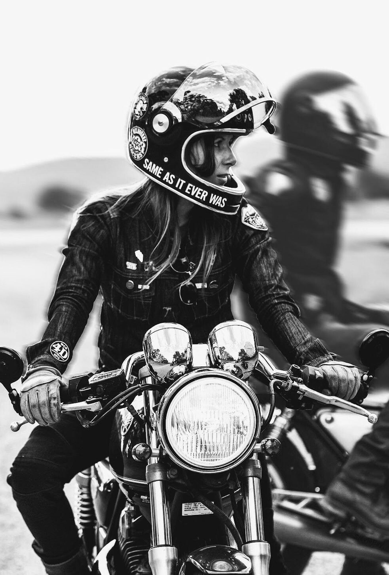 A female motorcyclist on a classic motorcycle. Media sourced from Pinterest.
