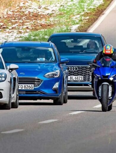 A view of cars driving next to motorcycles. Media courtesy of RideApart.