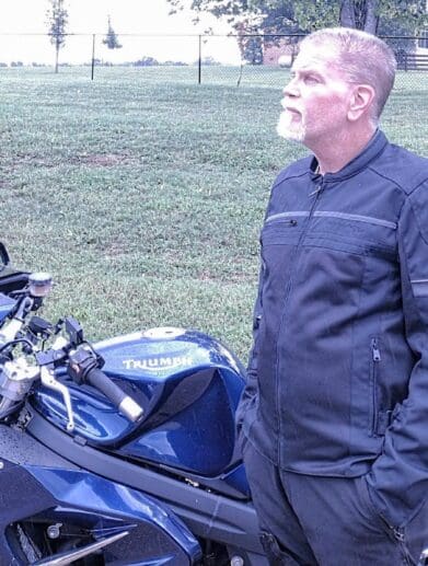 Author wearing Scorpion Cargo Air Jacket next to Triumph motorcycle