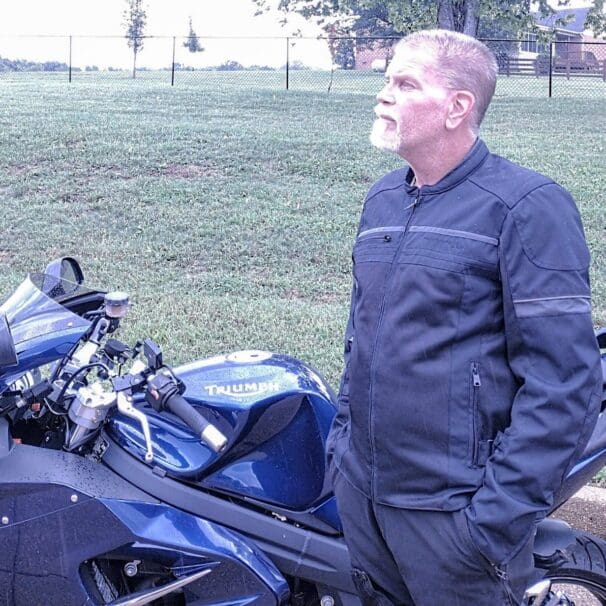 Author wearing Scorpion Cargo Air Jacket next to Triumph motorcycle