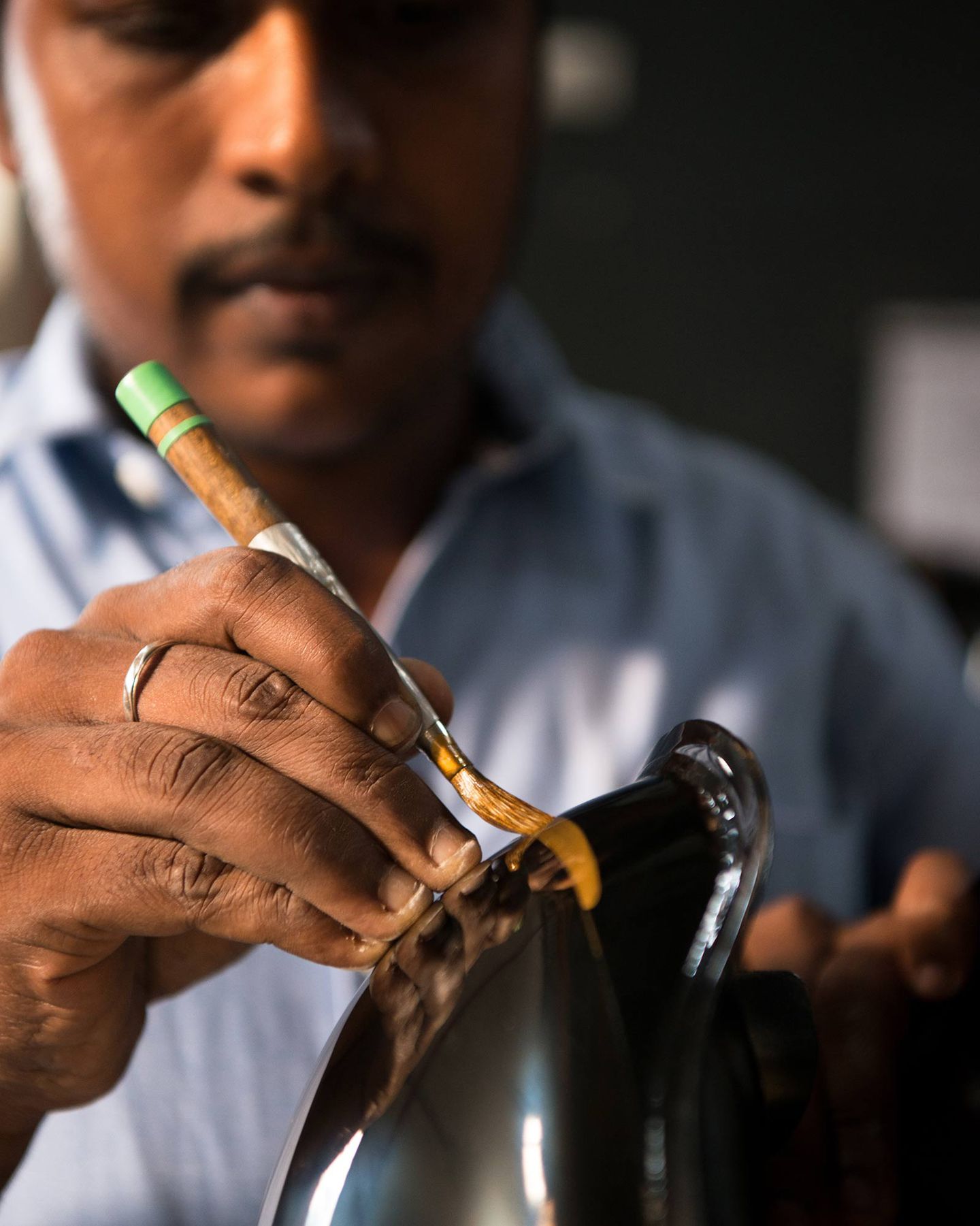 An artisan works on a motorcycle pinstripe. Media sourced from CycleWorld.