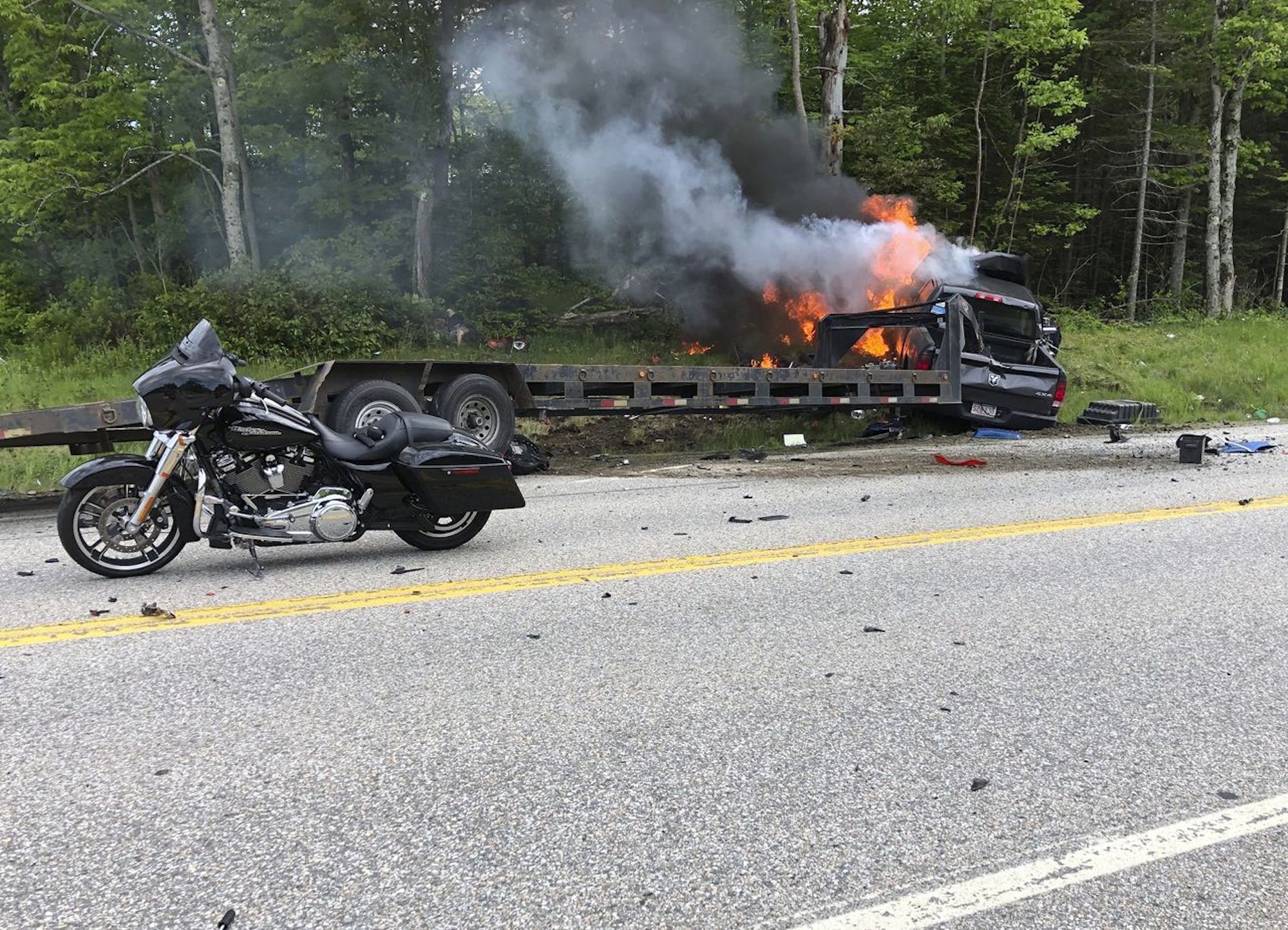 A view of a crashed motorcycle and truck accident.