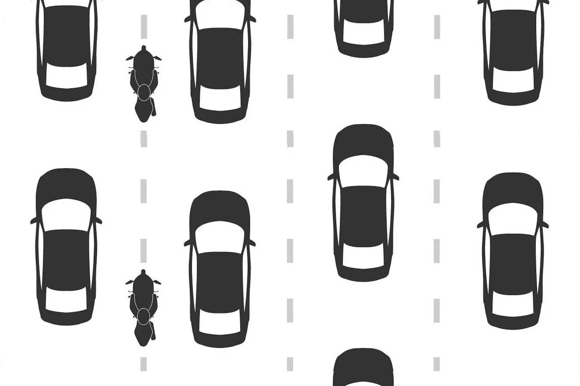 A rider lane filtering as cars wait at a stopped light. Media sourced from Asphalt & Rubber.