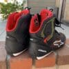 Alpinestars Faster 3 Rideknit shoes sitting on top of brick wall