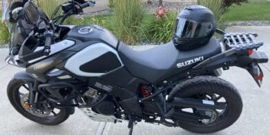 Bell Star DLX MIPS helmet resting on Suzuki motorcycle