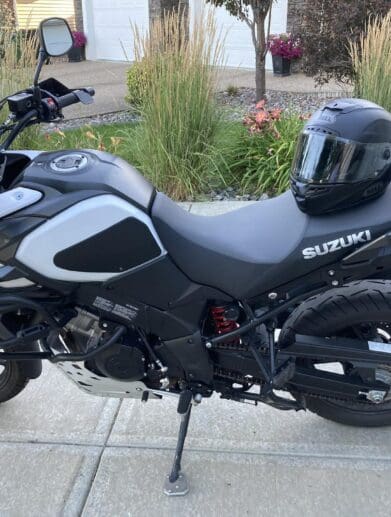 Bell Star DLX MIPS helmet resting on Suzuki motorcycle