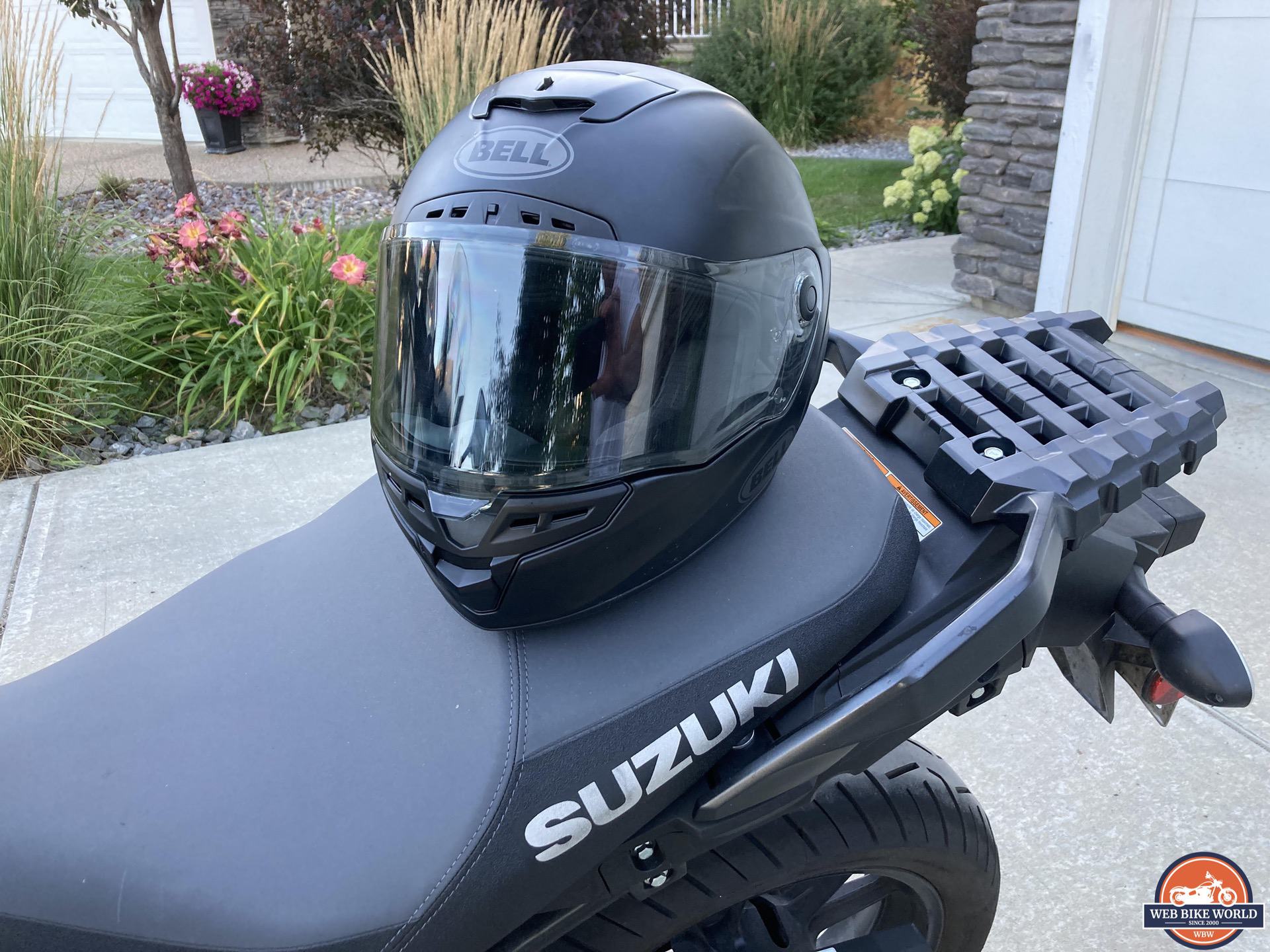 Viewport of Bell Star DLX MIPS helmet visible while helmet is resting on seat of Suzuki bike