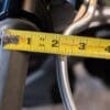 Measuring tape showing distance from motorcycle grip to brake lever normally