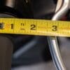 Measuring tape showing distance from motorcycle grip to brake lever normally