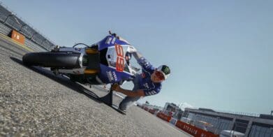 a man tries the “MotoGP Lean Angle Experience" at a race track