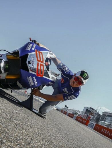 a man tries the “MotoGP Lean Angle Experience" at a race track