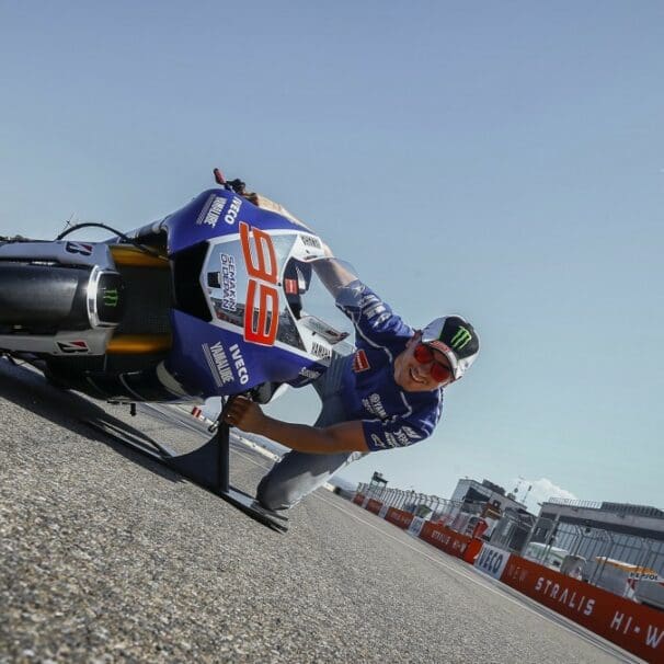 a man tries the “MotoGP Lean Angle Experience" at a race track