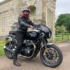 Rider wearing a helmet on a Triumph motorcycle