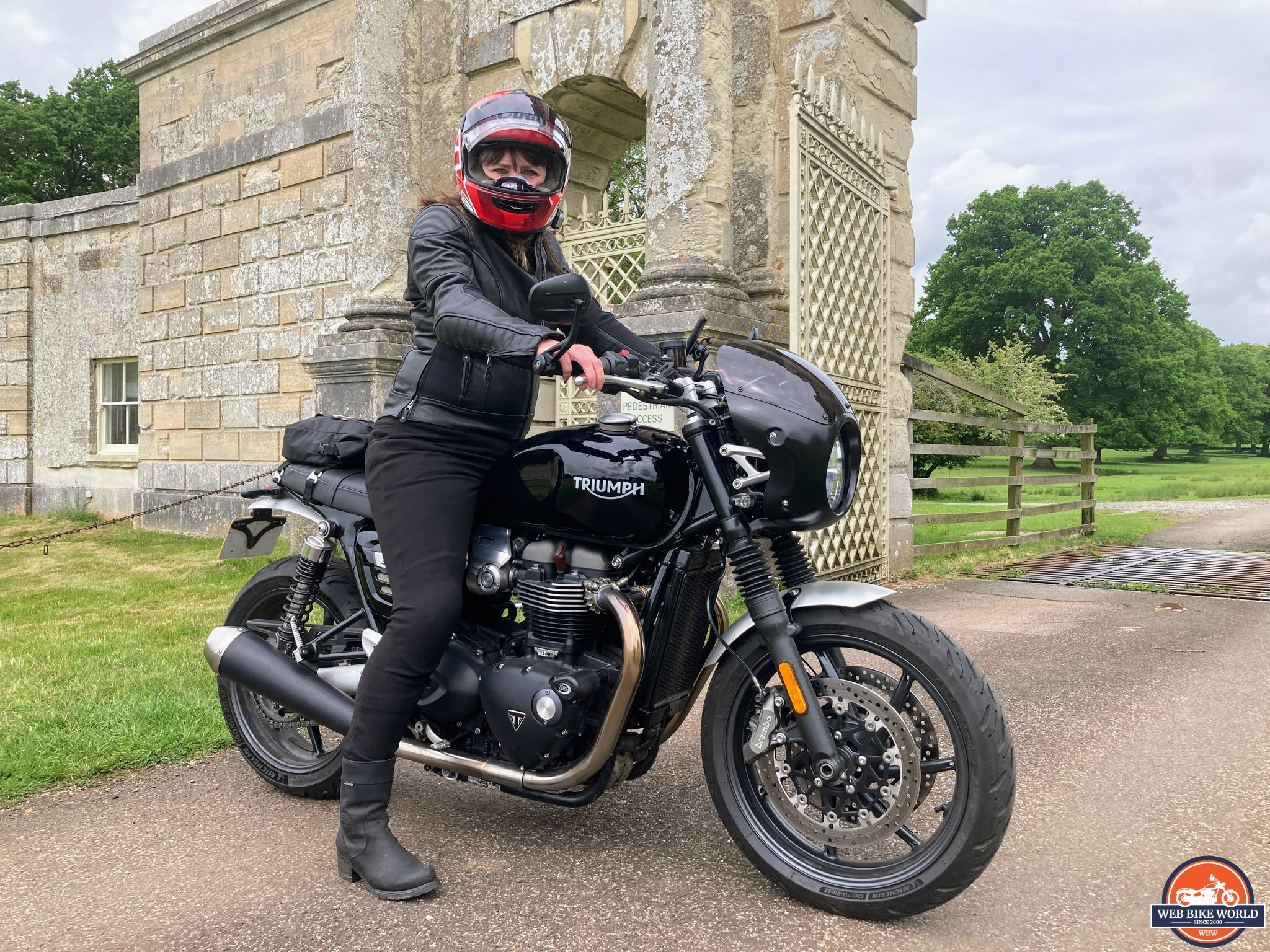 Rider wearing a helmet on a Triumph motorcycle