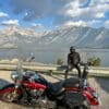 Author resting near mountain lake in Canadian Rockies while wearing Scorpion EXO Covert Ultra Jeans