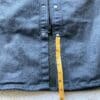 Measuring tape showing distance from bottom button to hem on Scorpion EXO Covert Waxed Riding Shirt