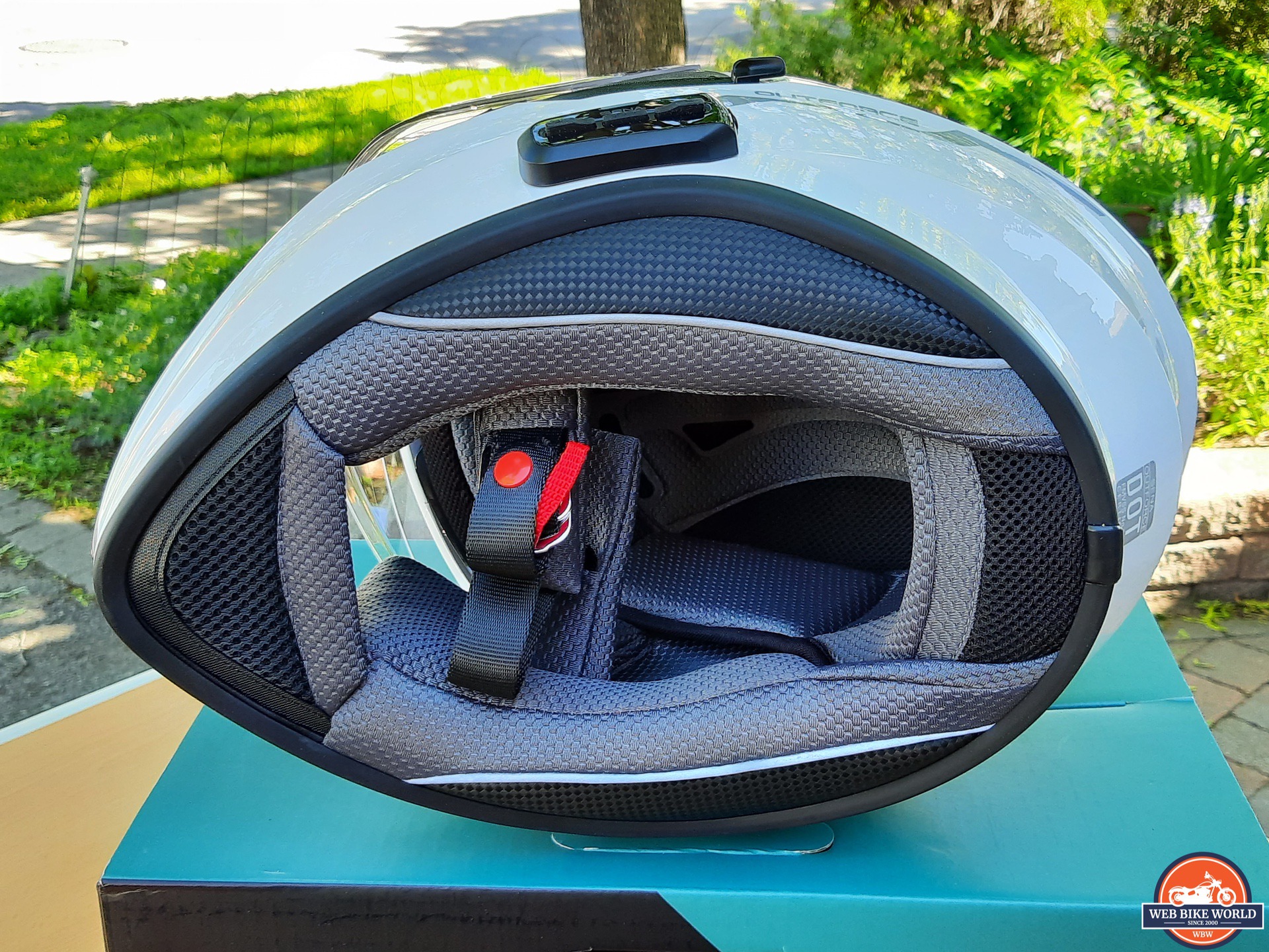 Sena OutForce Smart Helmet lying on side with interior liner visible
