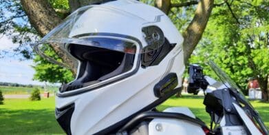 Sena OutForce Smart Helmet resting on motorcycle