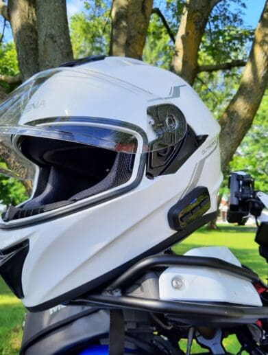 Sena OutForce Smart Helmet resting on motorcycle