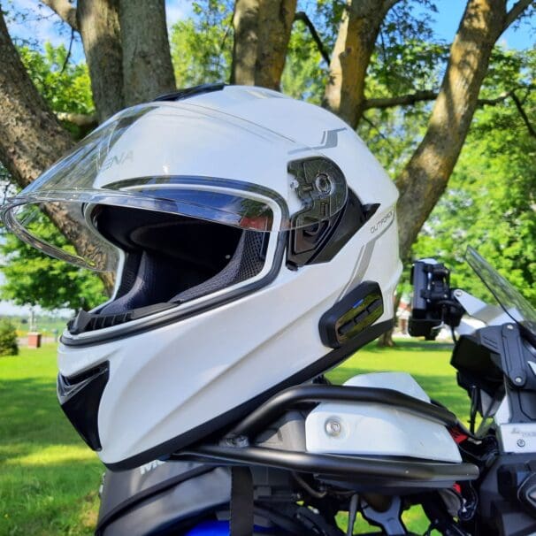 Sena OutForce Smart Helmet resting on motorcycle