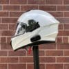 Side view of Sena OutForce Smart Helmet against brick wall