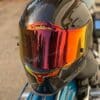 Icon Airframe Pro Carbon helmet sitting on rear of motorcycle