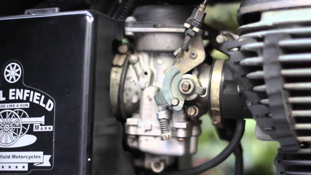 a detailed shot of a Royal Enfield carburettor on a motorcycle engine