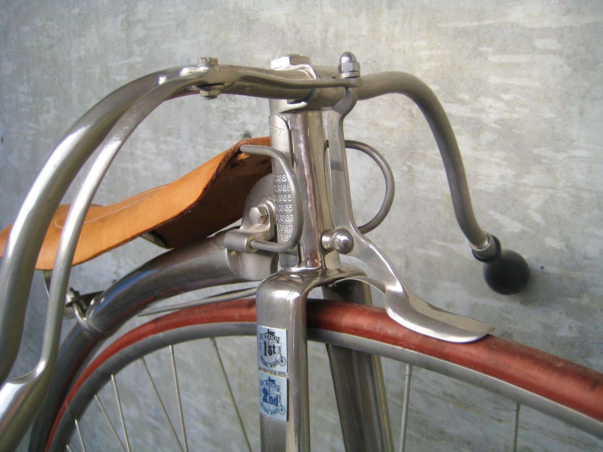 an old Penny Farthing bicycle close-up showing the spoon brake system