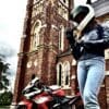 Author putting on Racer USA Women's Pitlane Gloves next to motorcycle