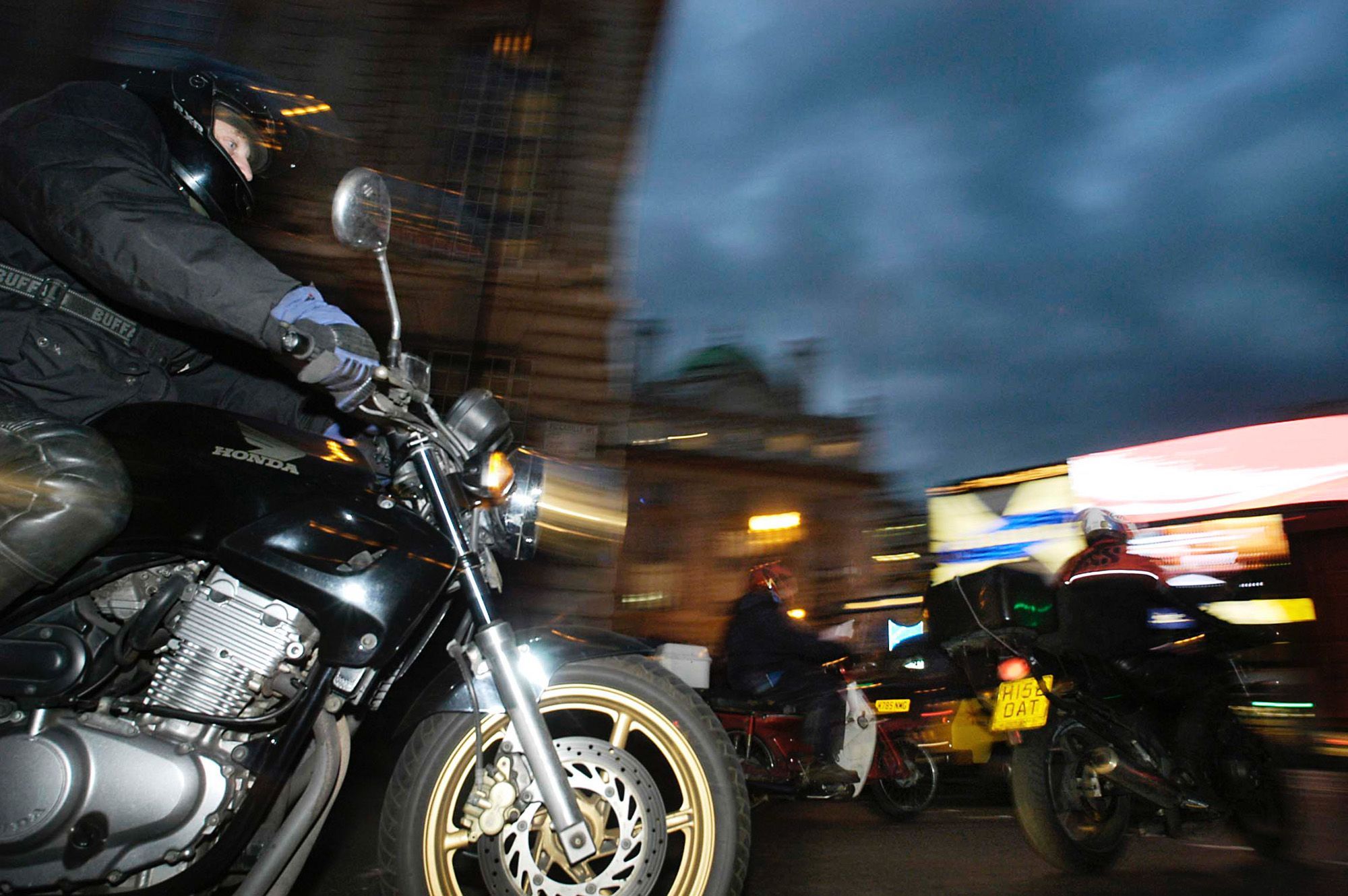 An urban motorcyclist riding at night. Media sourced from Bloomberg.