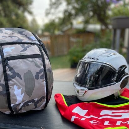 LS2 Valiant II modular helmet next to backpack