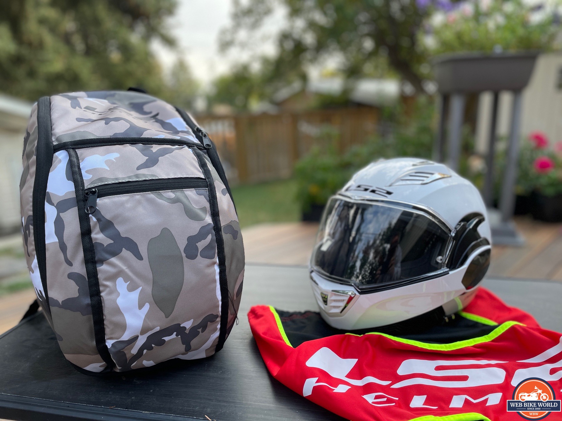 LS2 Valiant II modular helmet next to backpack