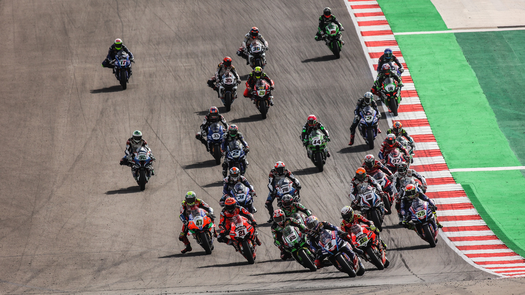 A crowd of WSBK racers approaching a lean. Media sourced from WSBK's website.