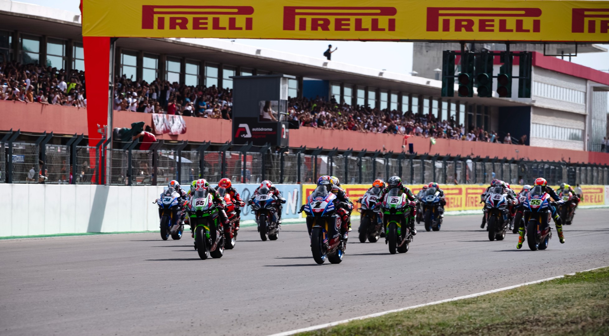 A crowd of WSBK racers blasting through the straightaway. Media sourced from WSBK's website.