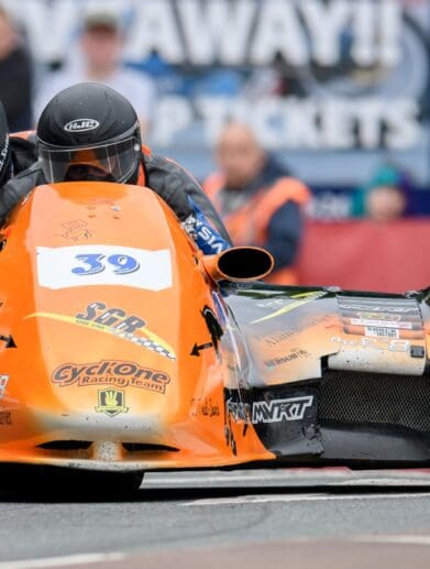 A view of Cesar Chanel and Olivier Lavorel in the opening race of the sidecar category for Isle of Man TT. Media sourced from ITV Hub.