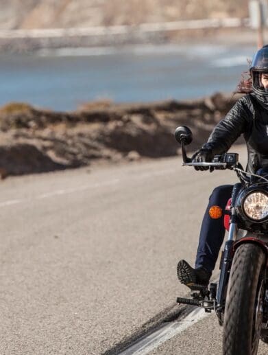 A female motorcyclist making her way down the highway. Media sourced from Conde Nast Traveler.