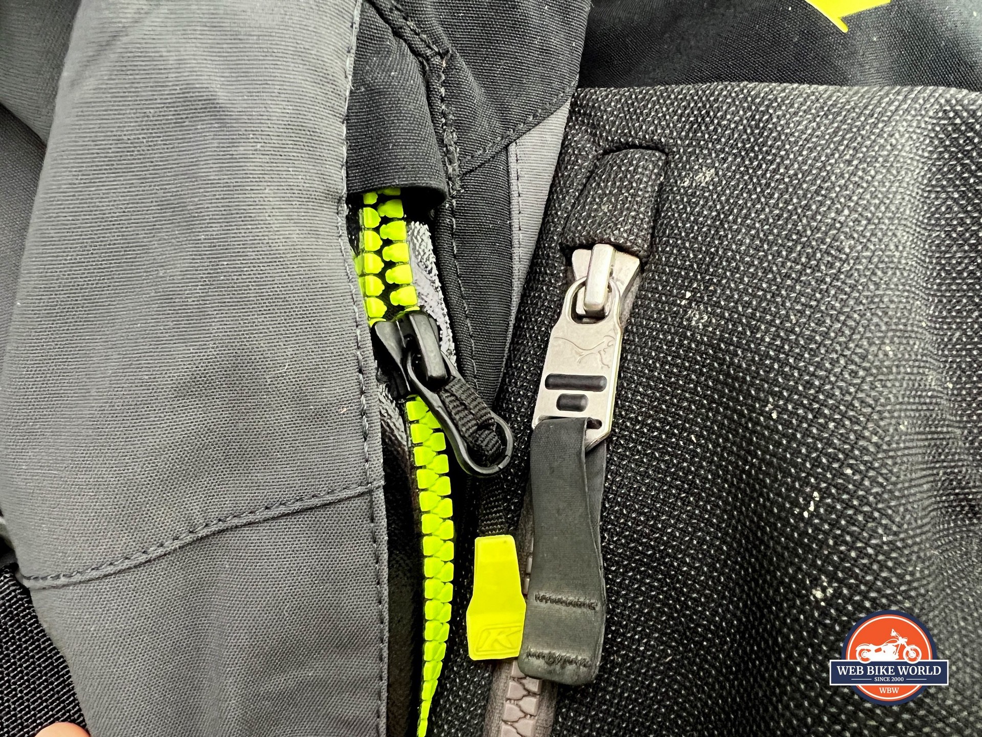 In this photo, you can see the huge difference in zipper pull tabs between the Klim and Mosko Moto jackets.