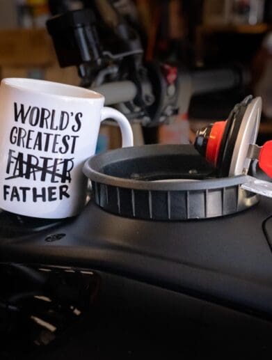 Novelty coffee mug on motorcycle fuel tank