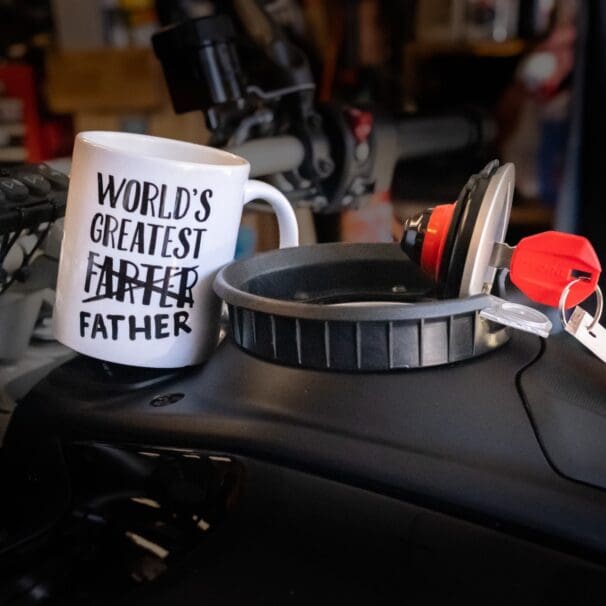 Novelty coffee mug on motorcycle fuel tank