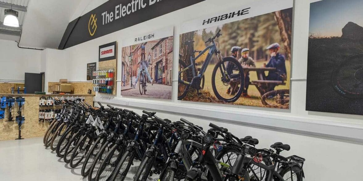 Row of Haibike and Raleigh electric bike models in store