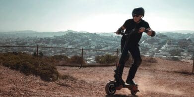 Man rides Varla eScooter uphill near neighbourhood