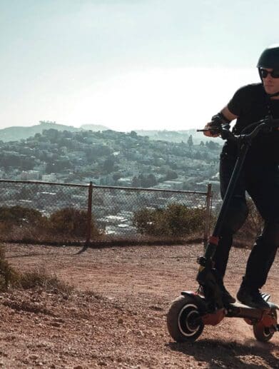 Man rides Varla eScooter uphill near neighbourhood