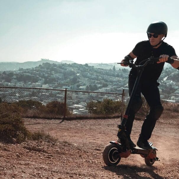 Man rides Varla eScooter uphill near neighbourhood