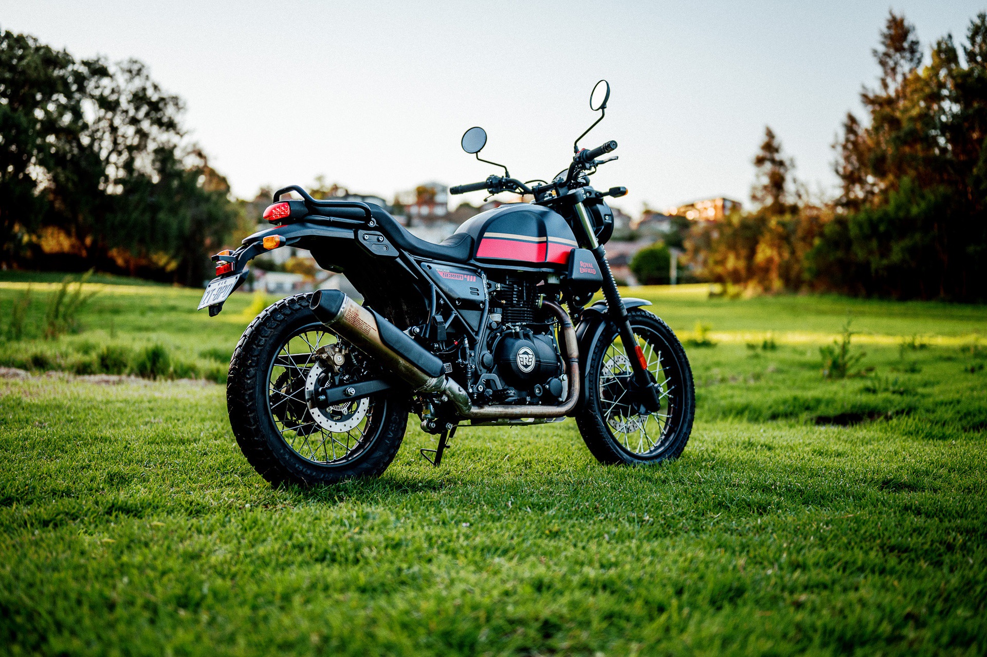 A 2022 Royal Enfield Scram 411 motorcycle in a park at dusk