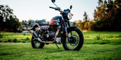 A 2022 Royal Enfield Scram 411 motorcycle in a park at dusk