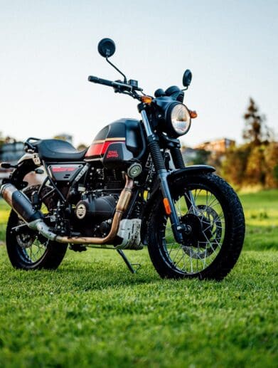 A 2022 Royal Enfield Scram 411 motorcycle in a park at dusk