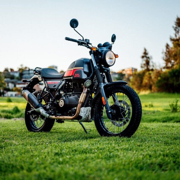 A 2022 Royal Enfield Scram 411 motorcycle in a park at dusk